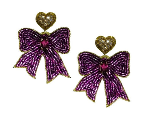 Purple bow-shaped earrings with gold accents on a white background